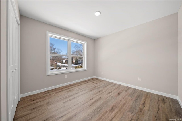 unfurnished bedroom featuring a closet and light hardwood / wood-style flooring