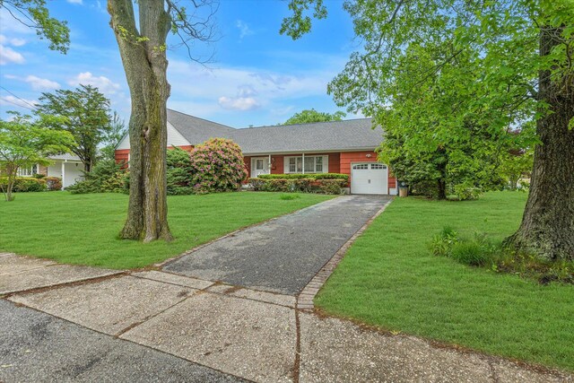 1519 Saint Louis Ave, Bay Shore, NY 11706 - view of front of house with a garage, a front lawn, asphalt driveway, and a shingled roof