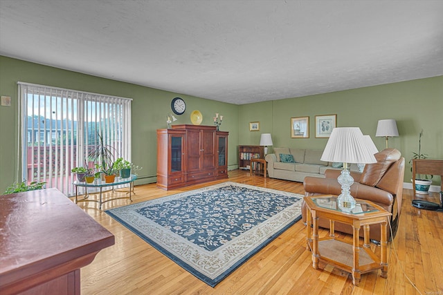 1519 Saint Louis Ave, Bay Shore, NY 11706 - living area with wood finished floors, a textured ceiling, and baseboard heating