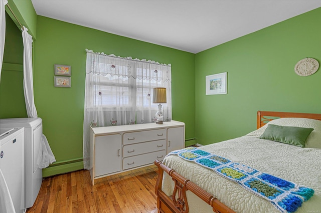 1519 Saint Louis Ave, Bay Shore, NY 11706 - bedroom with washer and dryer, wood finished floors, a baseboard radiator, and baseboard heating