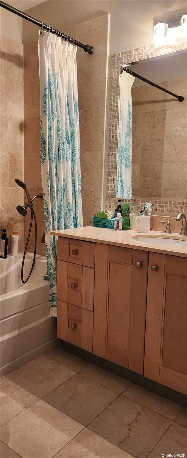 bathroom featuring tasteful backsplash, shower / tub combo with curtain, and vanity