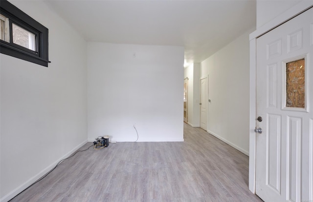 empty room with baseboards and wood finished floors