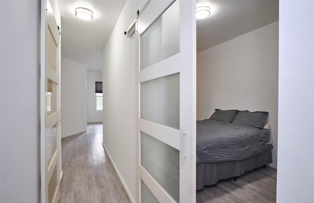 hallway featuring baseboards and wood finished floors
