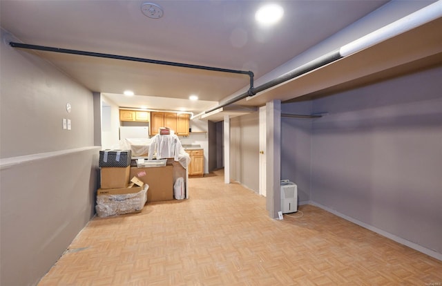 finished basement with baseboards and recessed lighting