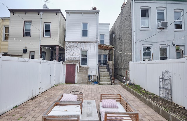 rear view of house featuring a patio area and a fenced backyard