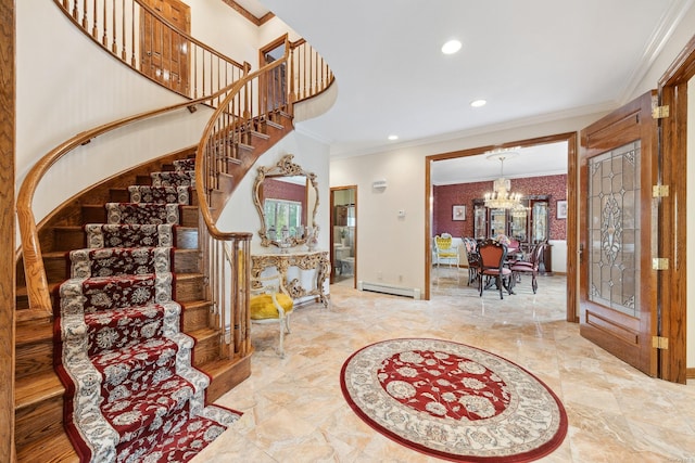 entrance foyer with a chandelier, a baseboard heating unit, ornamental molding, and stairs