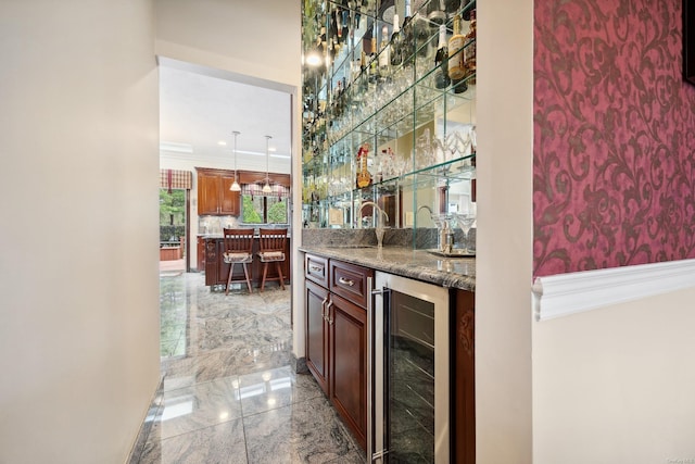 bar with a sink, granite finish floor, wet bar, wine cooler, and crown molding