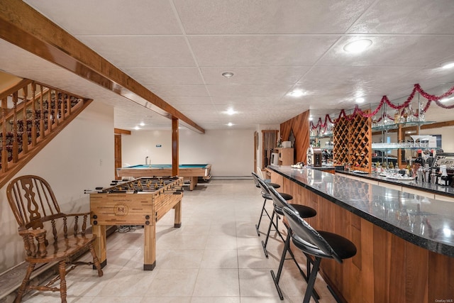 bar featuring a paneled ceiling, wet bar, pool table, and stairs