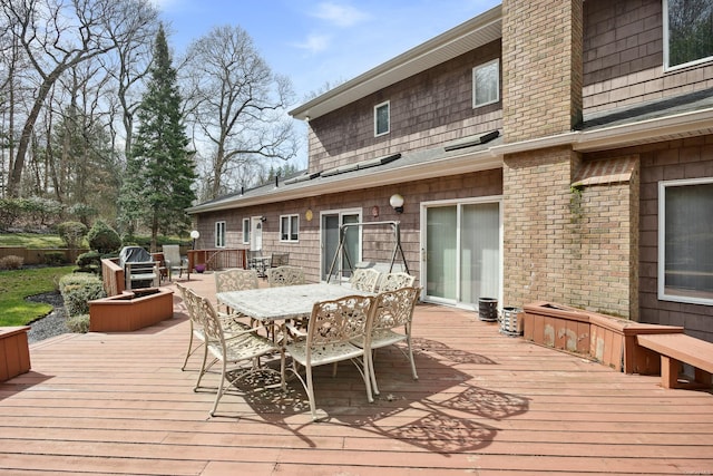 wooden deck featuring outdoor dining area