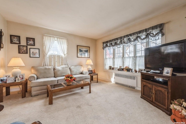 living room with light colored carpet and radiator heating unit