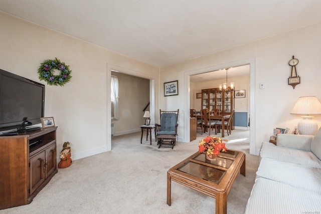 living room featuring light colored carpet and a notable chandelier