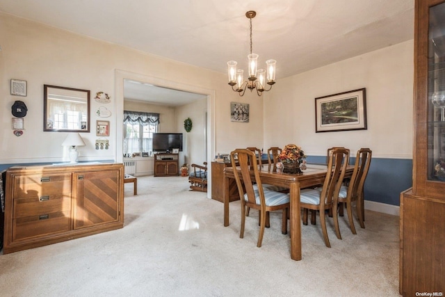 dining space featuring light carpet, radiator heating unit, and an inviting chandelier