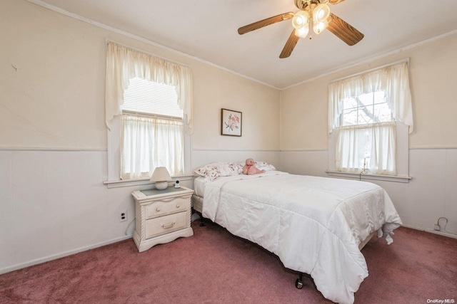 carpeted bedroom with ceiling fan and crown molding