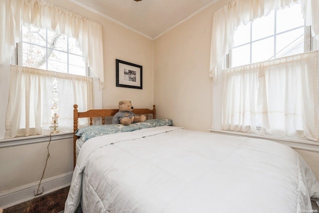 bedroom featuring ornamental molding and dark hardwood / wood-style floors