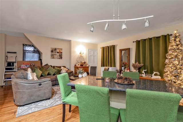 dining room featuring hardwood / wood-style floors and rail lighting