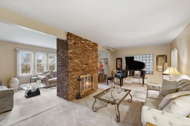 living room with carpet, radiator, a fireplace, and beamed ceiling