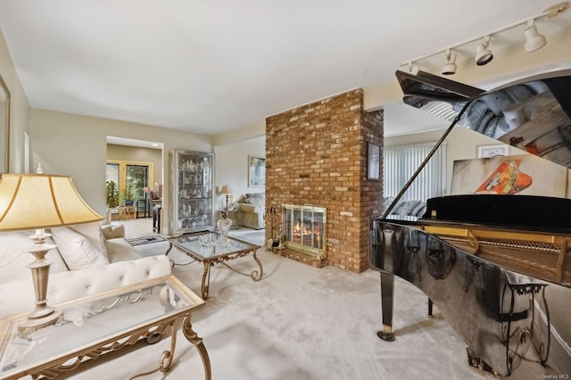 living room featuring carpet, a fireplace, and track lighting