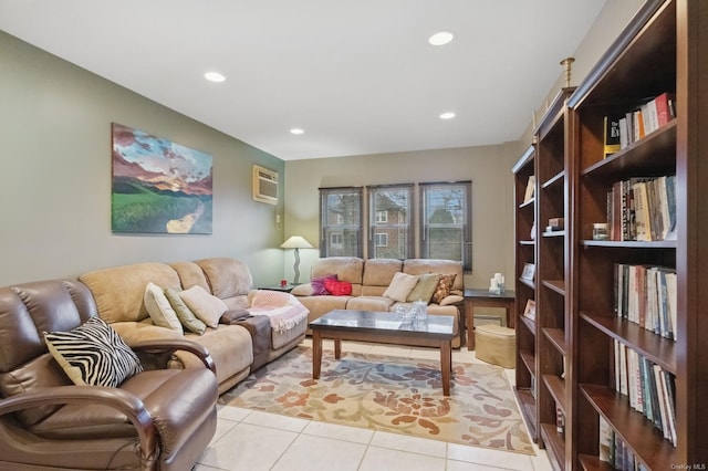 living room featuring light tile patterned floors and an AC wall unit