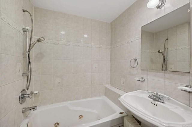 bathroom featuring sink, tile walls, and tiled shower / bath