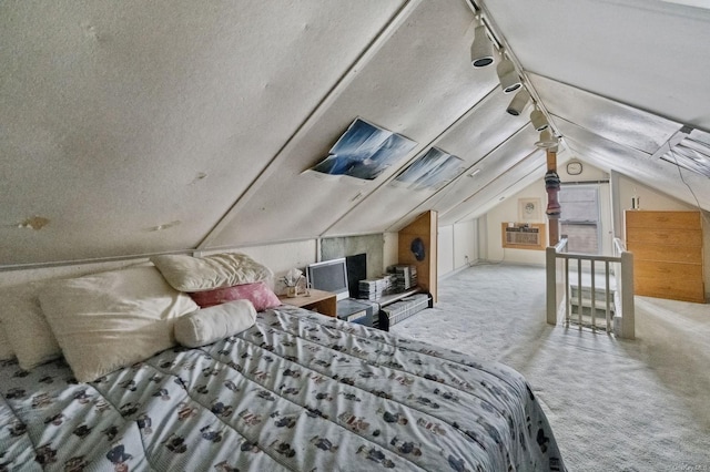 carpeted bedroom featuring a textured ceiling and vaulted ceiling