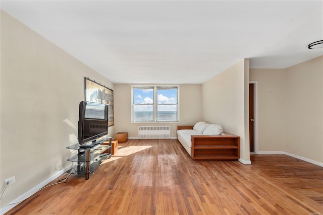 sitting room with light hardwood / wood-style flooring and radiator