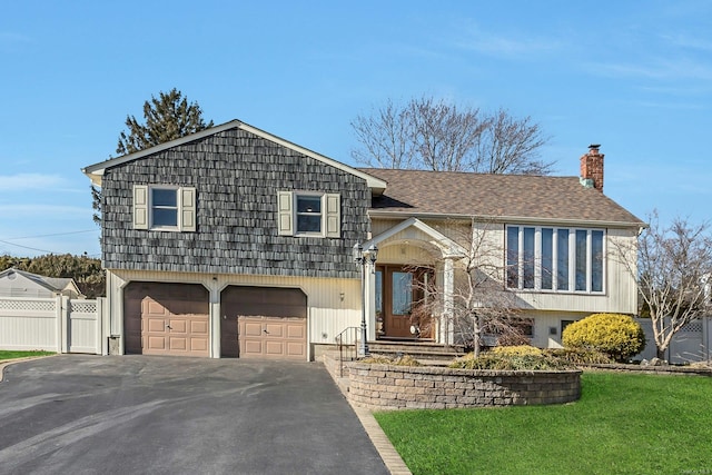 view of front facade with a garage and a front yard