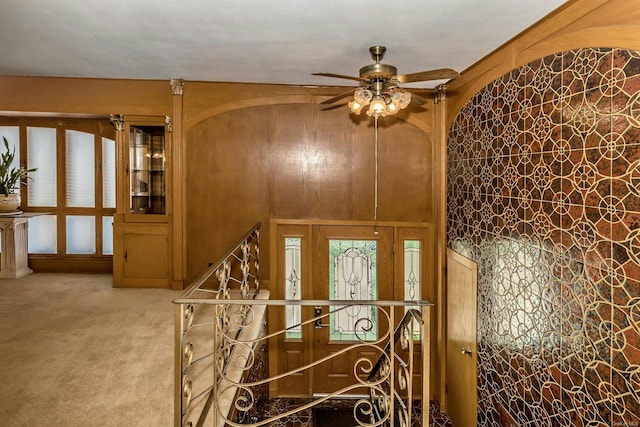 interior space featuring ceiling fan and light colored carpet