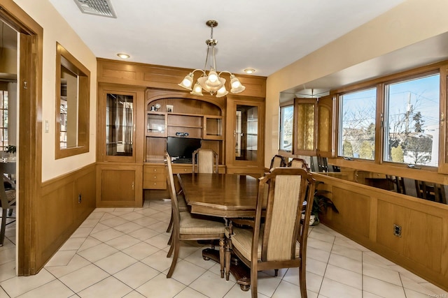 tiled dining room featuring a notable chandelier