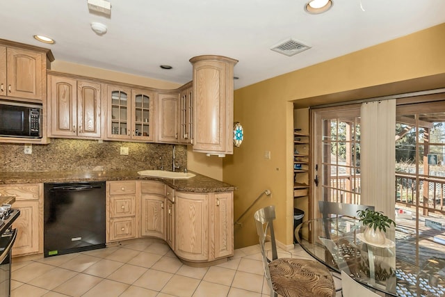 kitchen with sink, dark stone countertops, tasteful backsplash, black appliances, and light brown cabinets