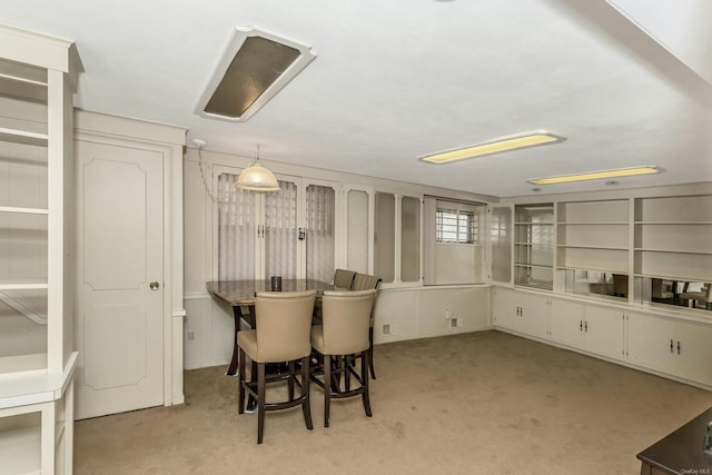 dining space with light colored carpet