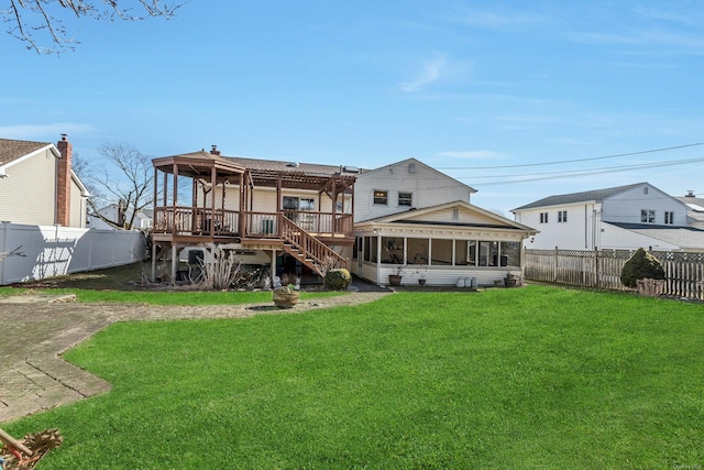 back of house with a wooden deck and a yard