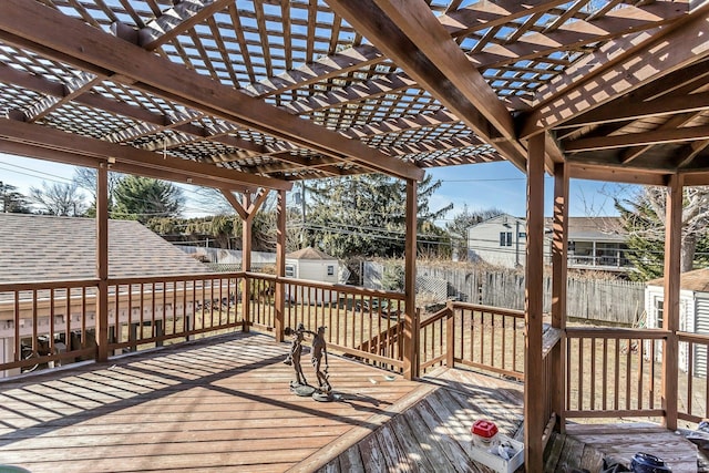 wooden terrace with a pergola and a shed