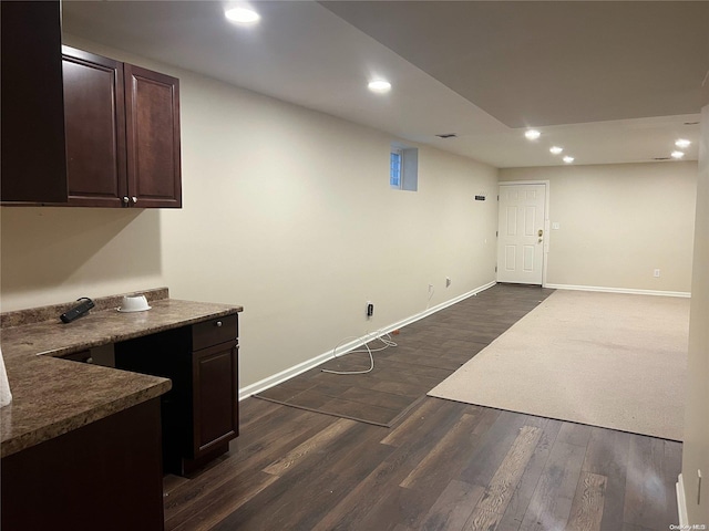 42-04 216th St, Bayside, NY 11361 - interior space with baseboards, dark brown cabinetry, dark wood-style flooring, open floor plan, and recessed lighting