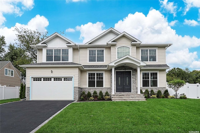 craftsman-style home with a front yard and a garage