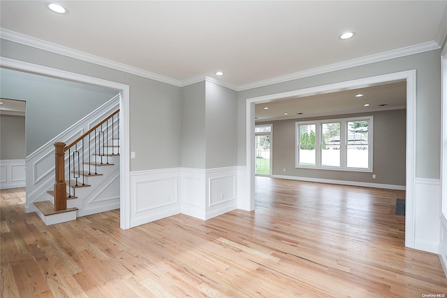 spare room with light hardwood / wood-style floors and ornamental molding