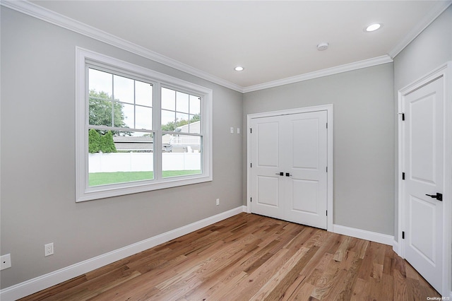 unfurnished bedroom featuring ornamental molding and light wood-type flooring