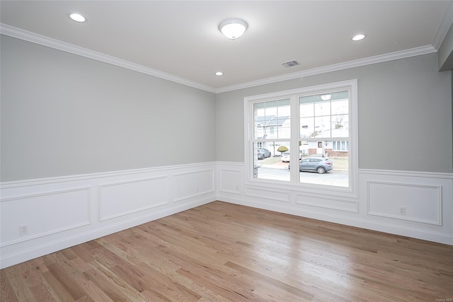 spare room featuring crown molding, light wood-type flooring, and recessed lighting