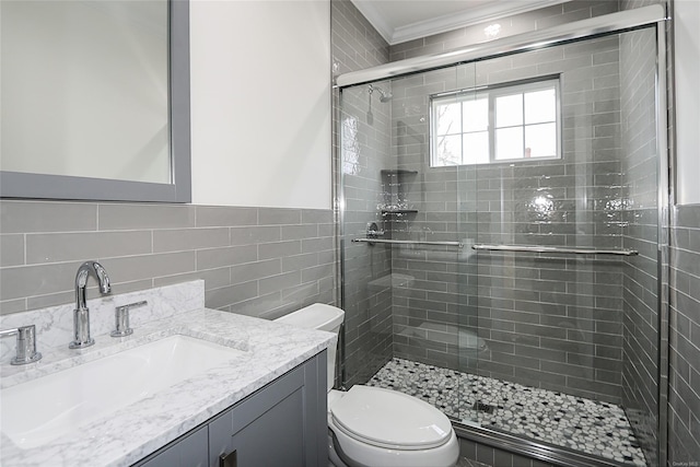 bathroom with toilet, a stall shower, tile walls, and vanity