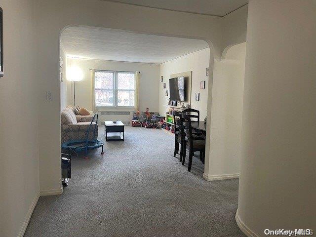 corridor with carpet floors and a textured ceiling