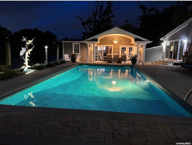 pool at twilight with a patio