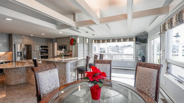 dining space with beam ceiling and a baseboard radiator