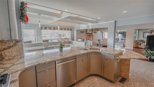 kitchen featuring stainless steel dishwasher, sink, light stone countertops, and kitchen peninsula