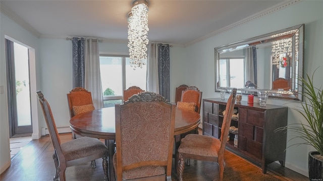 dining area with hardwood / wood-style flooring, an inviting chandelier, crown molding, and a baseboard radiator