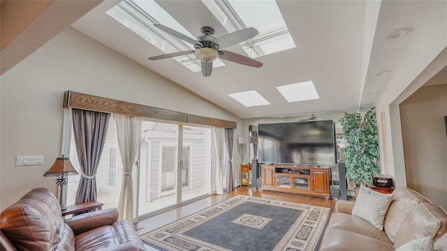 living room with ceiling fan, light hardwood / wood-style floors, and lofted ceiling