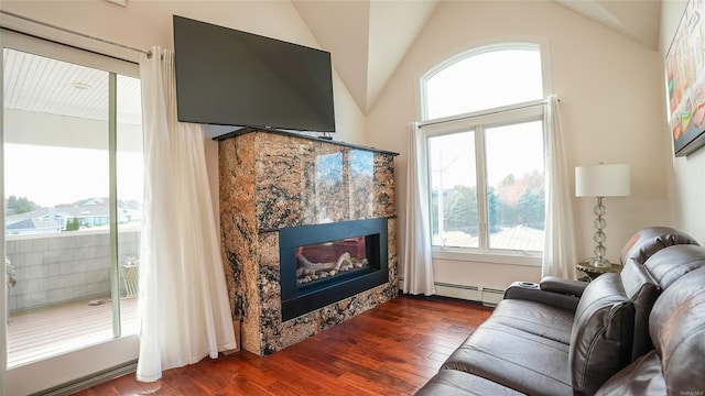 living room featuring a tile fireplace, a baseboard heating unit, dark hardwood / wood-style flooring, and lofted ceiling