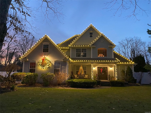 view of front of home with a lawn and covered porch