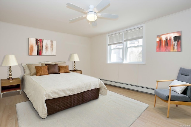 bedroom with ceiling fan, a baseboard radiator, and hardwood / wood-style flooring