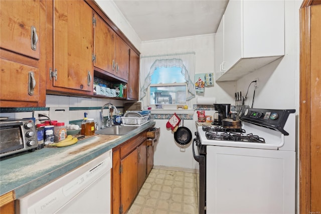 kitchen with backsplash, white cabinetry, white appliances, and sink