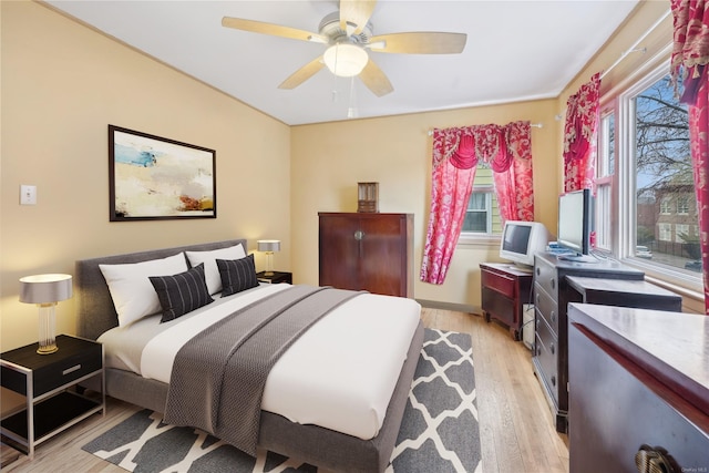 bedroom with light wood-type flooring and ceiling fan