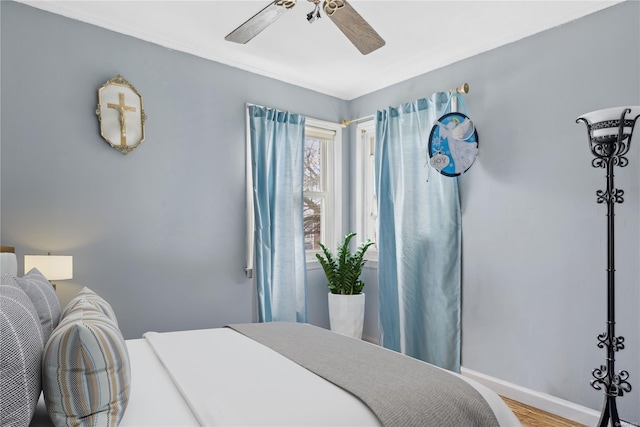 bedroom with hardwood / wood-style flooring and ceiling fan